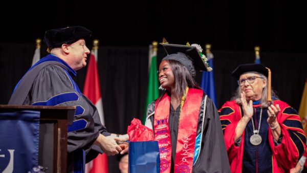 Smith accepts her Leona J. Ablah Award at the spring 2026 Newman commencement ceremony.
