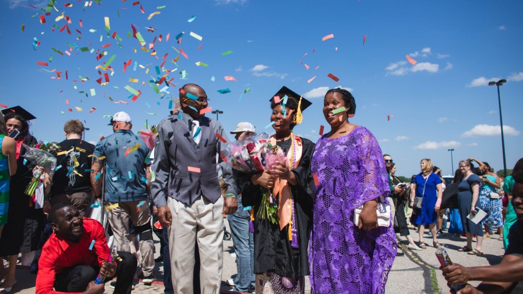 Graduates celebrate outside the Heartland Credit Union Arena.