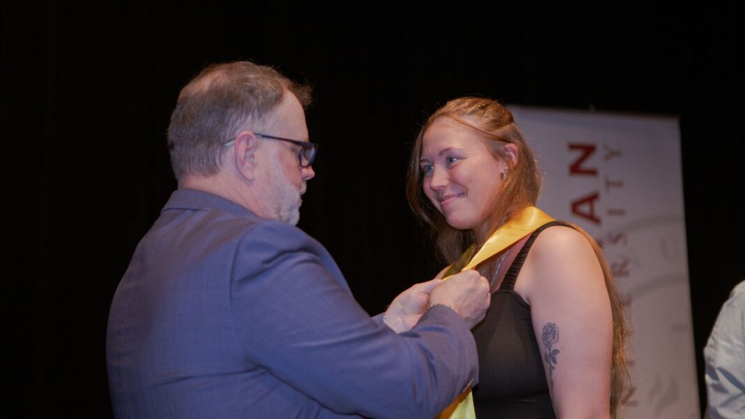 Graduates receive their ceremonial pins.
