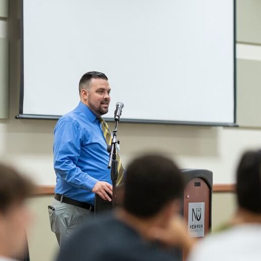 Nance addresses an audience at a business mixer at Newman University.