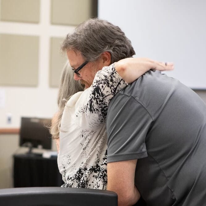 Jagger embraces Sanny in a congratulatory hug.