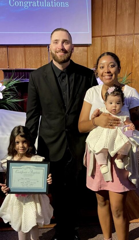 Cierra posing with her husband and daughters