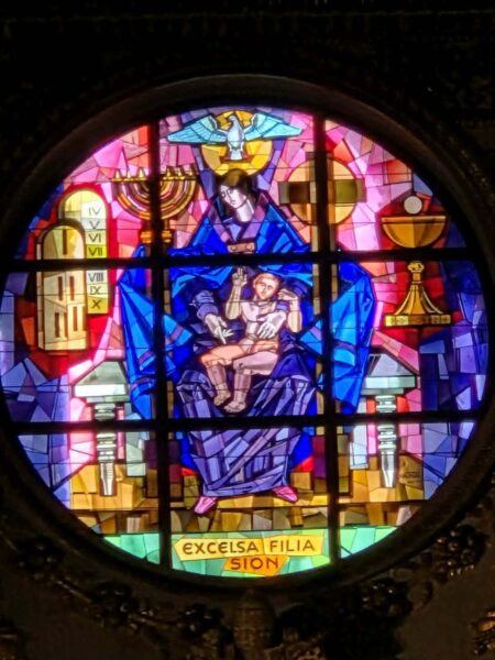 A stained glass window in the Basilica of Saint Mary depicts the Virgin Mary and Jesus.