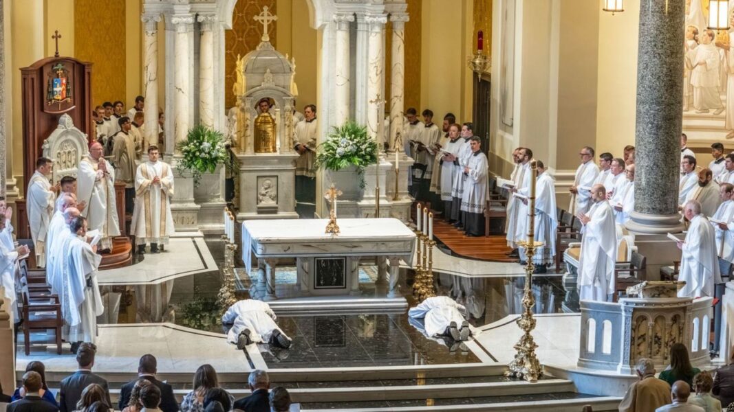 The newly ordained transitional deacons lay prostrate at the Cathedral of the Immaculate Conception during their ordination ceremony.