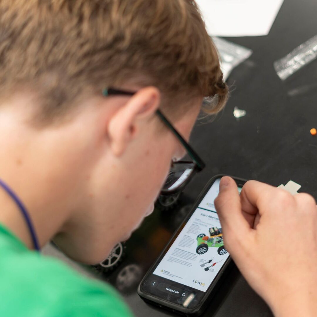 Taylor studies a diagram of the motorized vehicle.
