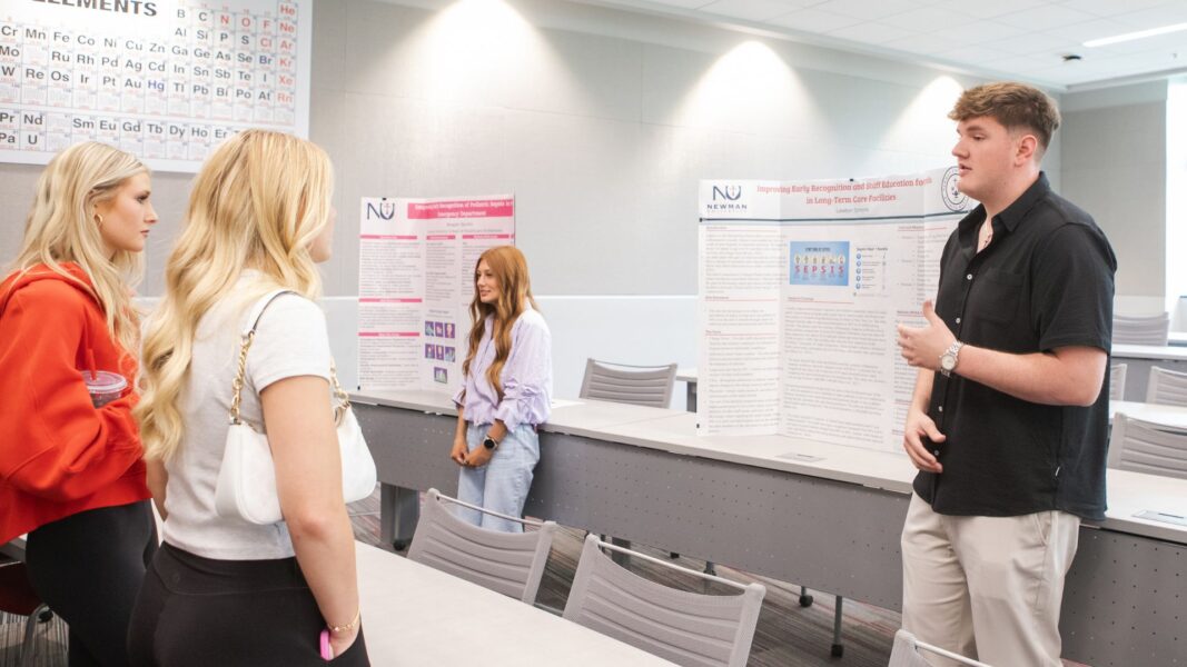 Simons presents during Scholars Day at Newman University.