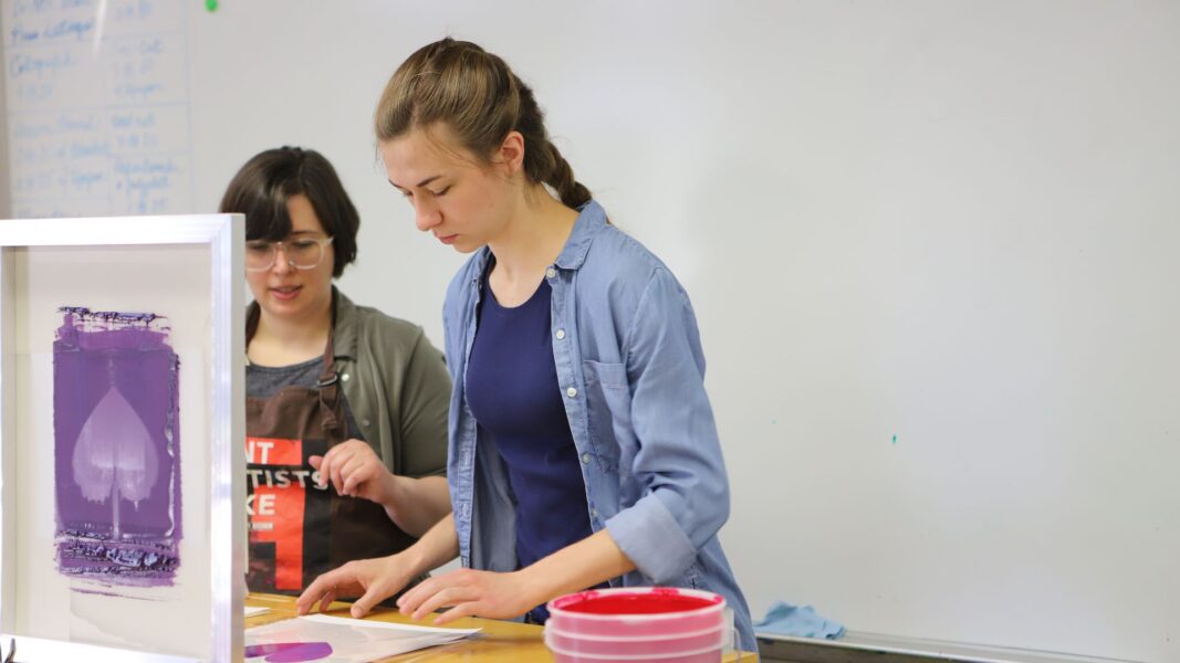 Strickbine worked with Professor Ritter during a printmaking demonstration in an art class.