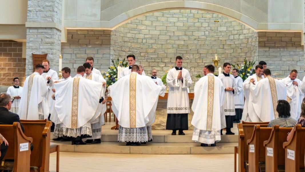The six Wichita priests wear their liturgical vestments for the first time.