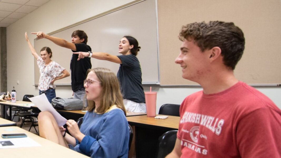 Strickbine (far left) raises her hand during an Honors Program game.