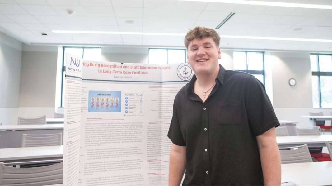 Simons presents his nursing research during Newman Scholars Day.