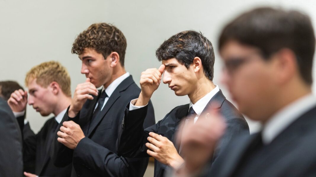 During Mass in St. John's Chapel, seminarians make the sign of the cross to signify Jesus is welcome in their minds, in their words and in their hearts.