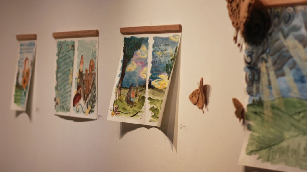 Illustrations from Strickbine's "Walks with Joy" line the walls of the Steckline Gallery.