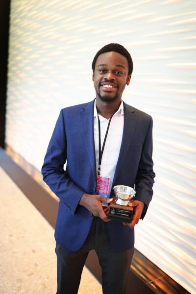 Kelly Lotsu-Morgan holding his Technology Student of the Year award.