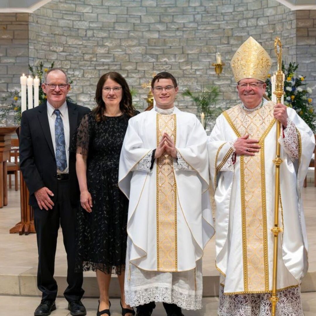 McGuire with his parents and Bishop Kemme (Courtesy photo: Catholic Advance)