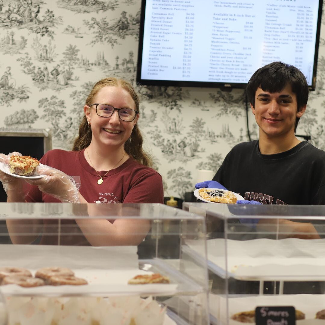 Real and a co-worker at Cottage Crumbs show off some pastries.