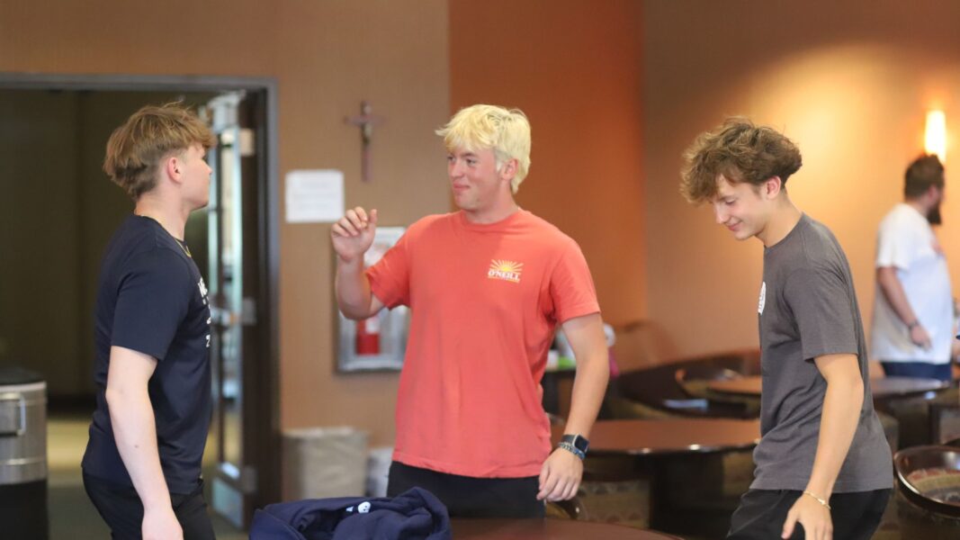 Students smile as they connect during Flight Nite, an overnight experience for incoming students at Newman University.