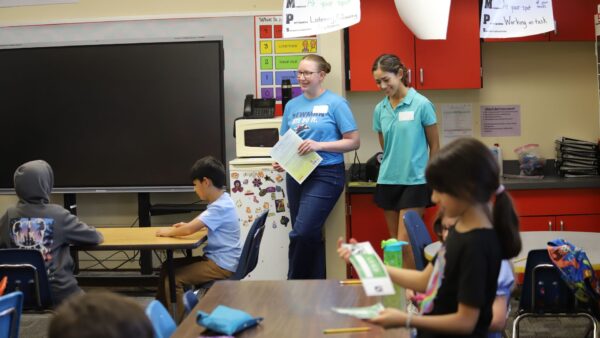 (Left) Real prepares to read a bilingual book to students in the classroom at Stanley Elementary School.